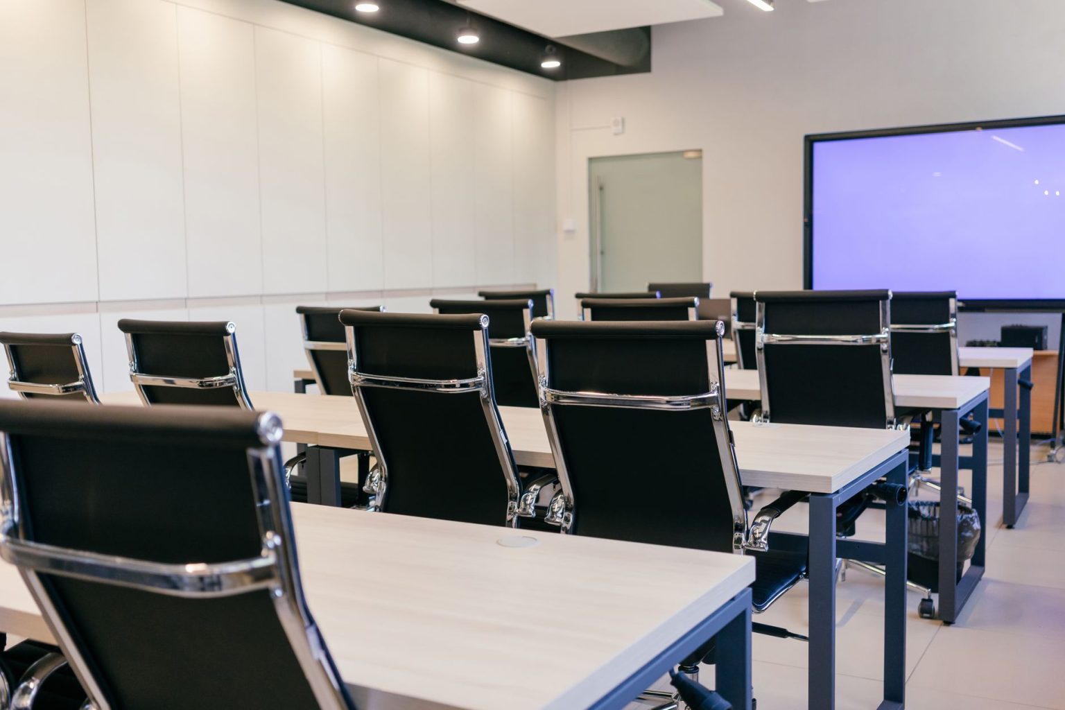 Spacious meeting room with projector screen
